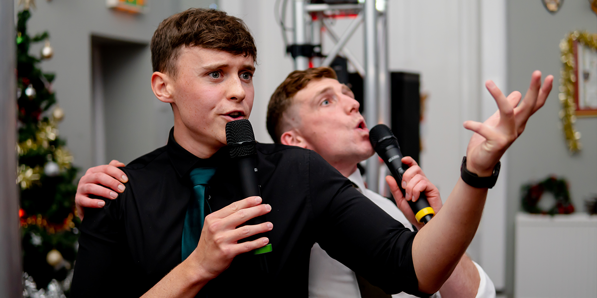 Men singing karaoke